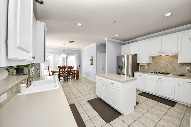 2613 Broussard Ct, Seabrook, TX 77586 - kitchen with stainless steel fridge, light tile patterned floors, crown molding, backsplash, and light countertops