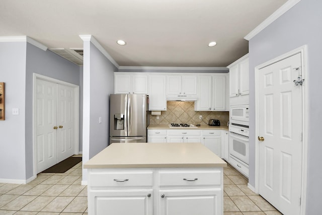 2613 Broussard Ct, Seabrook, TX 77586 - kitchen featuring white appliances, under cabinet range hood, light tile patterned flooring, decorative backsplash, and recessed lighting