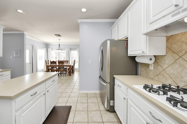 2613 Broussard Ct, Seabrook, TX 77586 - kitchen featuring extractor fan, crown molding, white gas cooktop, white cabinetry, and light countertops