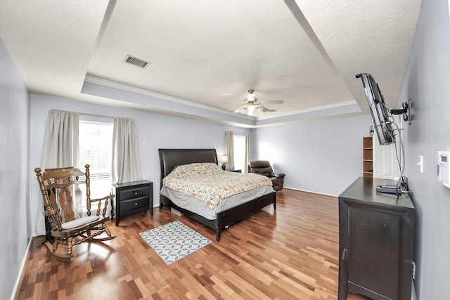 2613 Broussard Ct, Seabrook, TX 77586 - bedroom with a raised ceiling, wood finished floors, ceiling fan, and ornamental molding