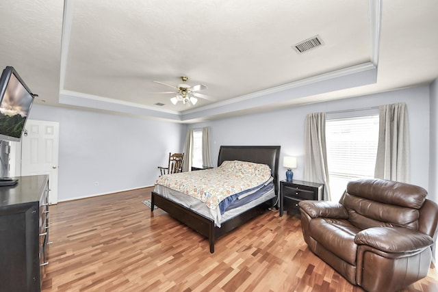 2613 Broussard Ct, Seabrook, TX 77586 - bedroom with a raised ceiling, light wood finished floors, crown molding, and a ceiling fan