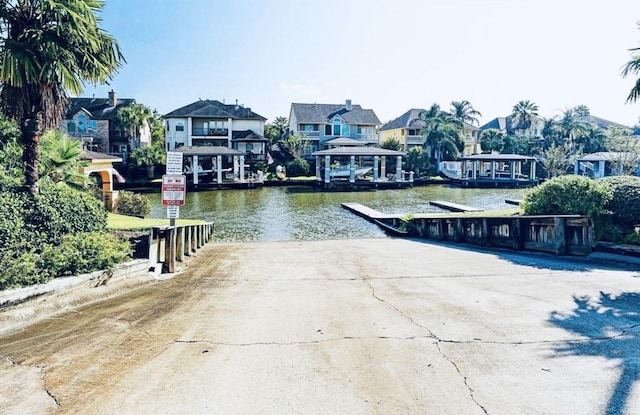 2613 Broussard Ct, Seabrook, TX 77586 - dock featuring a boat ramp, a residential view, and a water view