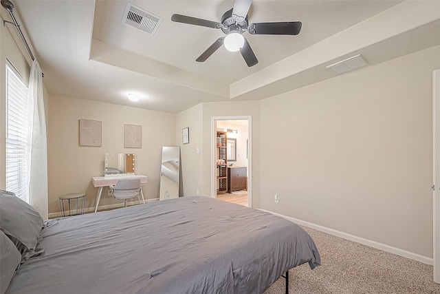 2335 Village Leaf Dr, Spring, TX 77386 - bedroom with a raised ceiling, light carpet, connected bathroom, and ceiling fan