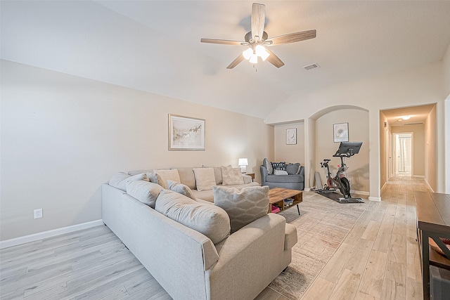 2335 Village Leaf Dr, Spring, TX 77386 - living area with light wood-style floors, ceiling fan, lofted ceiling, and arched walkways