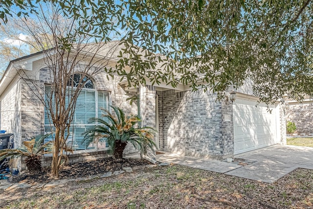 2335 Village Leaf Dr, Spring, TX 77386 - view of front of house with an attached garage and brick siding
