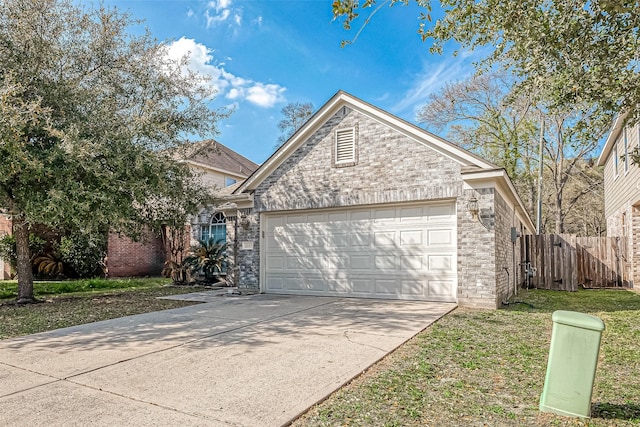 2335 Village Leaf Dr, Spring, TX 77386 - view of front of house with concrete driveway, an attached garage, and stone siding