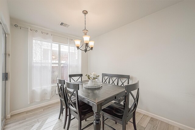 2335 Village Leaf Dr, Spring, TX 77386 - dining area featuring a chandelier and light wood finished floors