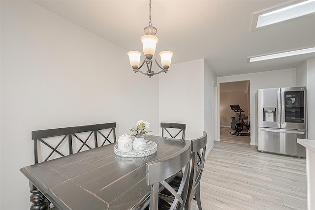2335 Village Leaf Dr, Spring, TX 77386 - dining room featuring light wood finished floors and a chandelier
