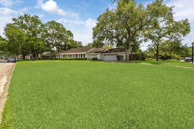 7525 Middlewood St, Houston, TX 77063 - view of green lawn with an attached garage