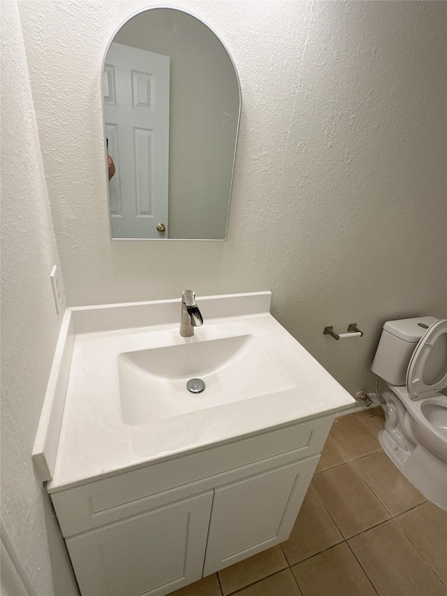 13426 Sanderford Ln, Houston, TX 77083 - bathroom featuring tile patterned flooring, vanity, and a textured wall