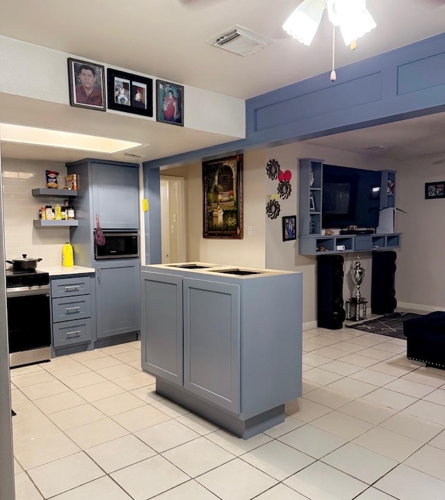 7722 Breezeway St, Houston, TX 77040 - kitchen featuring stainless steel appliances, open shelves, light tile patterned flooring, gray cabinets, and light countertops