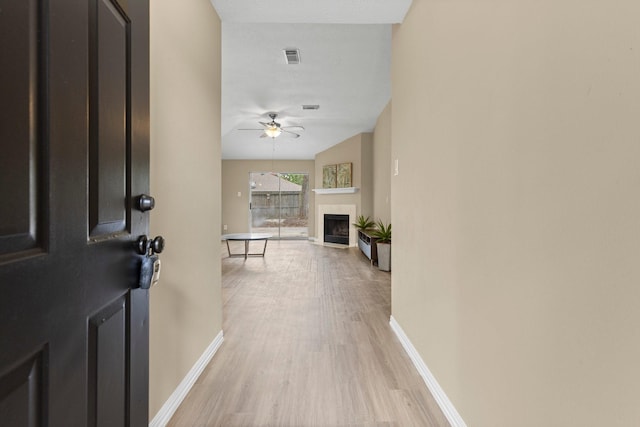 29222 Waltham St, Spring, TX 77386 - foyer featuring light wood-style flooring, a ceiling fan, and a fireplace with flush hearth