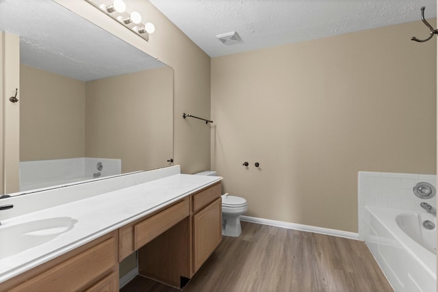 29222 Waltham St, Spring, TX 77386 - full bathroom featuring vanity, a garden tub, wood finished floors, and a textured ceiling