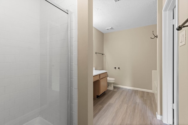 29222 Waltham St, Spring, TX 77386 - full bath featuring wood finished floors, a stall shower, vanity, and a textured ceiling