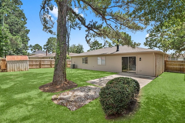 29222 Waltham St, Spring, TX 77386 - back of property with a fenced backyard, a storage unit, and a patio
