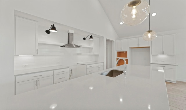 21230 Blue Bluff Dr, Cypress, TX 77433 - kitchen with wall chimney exhaust hood, decorative backsplash, white cabinets, vaulted ceiling, and light countertops