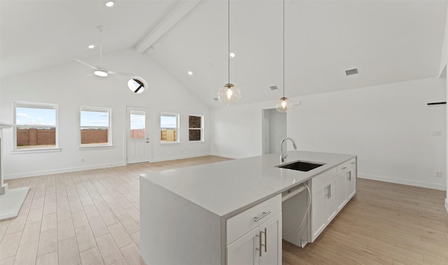 21230 Blue Bluff Dr, Cypress, TX 77433 - kitchen featuring stainless steel dishwasher, high vaulted ceiling, open floor plan, beam ceiling, and light wood-type flooring