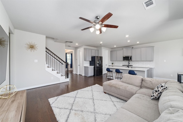187 Solana Point Dr, Katy, TX 77493 - living area with ceiling fan, recessed lighting, dark wood-style floors, and stairway