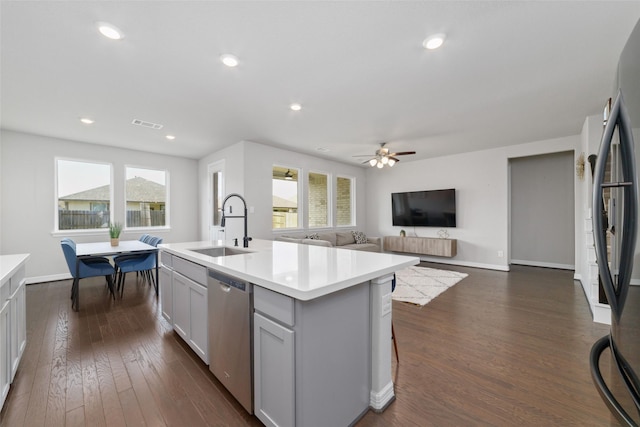 187 Solana Point Dr, Katy, TX 77493 - kitchen with stainless steel appliances, light countertops, dark wood finished floors, a center island with sink, and recessed lighting