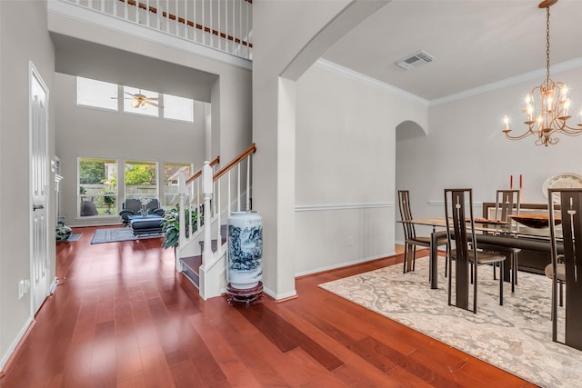13811 Brannon Field Ln, Houston, TX 77041 - dining area featuring arched walkways, wood finished floors, ceiling fan, stairway, and ornamental molding
