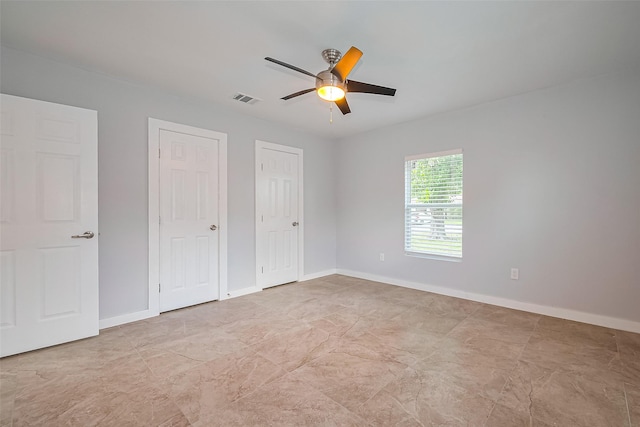 52 Penway St, Houston, TX 77022 - unfurnished bedroom with two closets and ceiling fan
