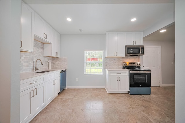 52 Penway St, Houston, TX 77022 - kitchen featuring appliances with stainless steel finishes, tasteful backsplash, light countertops, white cabinetry, and recessed lighting