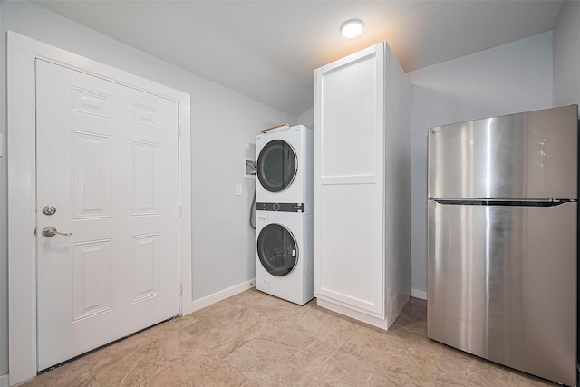 52 Penway St, Houston, TX 77022 - laundry area with estacked washer and dryer and baseboards