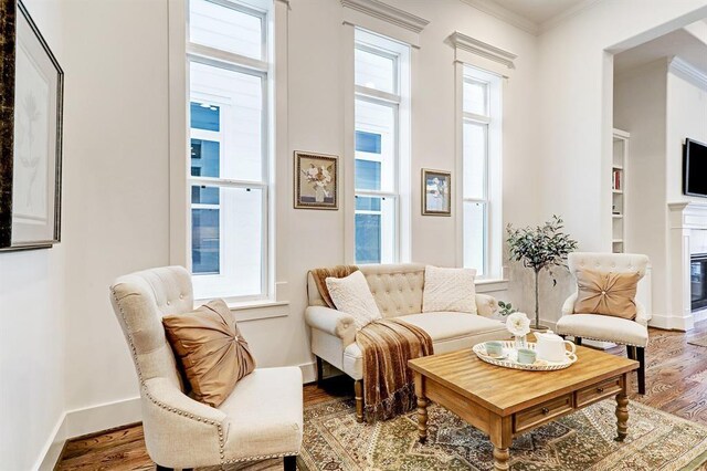 325 W 23rd St, Houston, TX 77008 - living room with crown molding, wood finished floors, and a glass covered fireplace