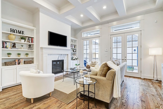 325 W 23rd St, Houston, TX 77008 - living area with light wood-style floors, beamed ceiling, a fireplace, coffered ceiling, and ornamental molding
