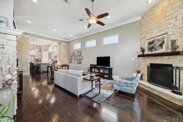 1219 W 25th St Unit A, Houston, TX 77008 - living area featuring decorative columns, a stone fireplace, ceiling fan, ornamental molding, and dark wood-type flooring