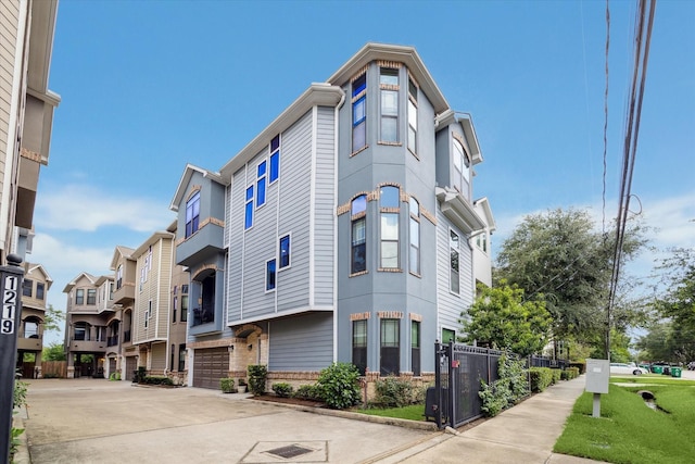 1219 W 25th St Unit A, Houston, TX 77008 - view of building exterior featuring an attached garage and concrete driveway