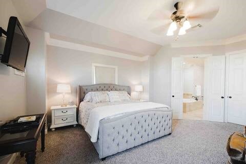 1616 Southmore Blvd, Houston, TX 77004 - bedroom with carpet flooring, connected bathroom, vaulted ceiling, and ceiling fan