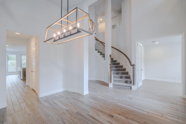 17010 Harpers Way, Conroe, TX 77385 - entrance foyer with light wood finished floors, stairway, and recessed lighting