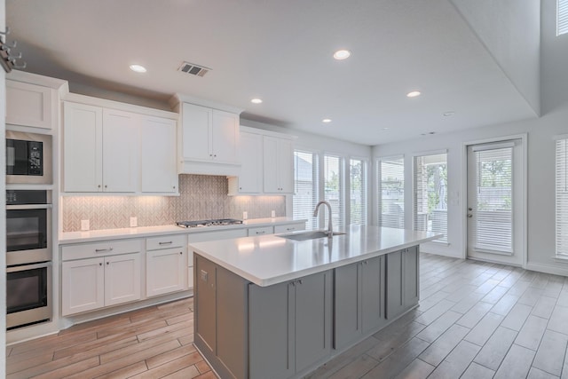 17010 Harpers Way, Conroe, TX 77385 - kitchen featuring healthy amount of natural light, light countertops, light wood-type flooring, backsplash, and recessed lighting