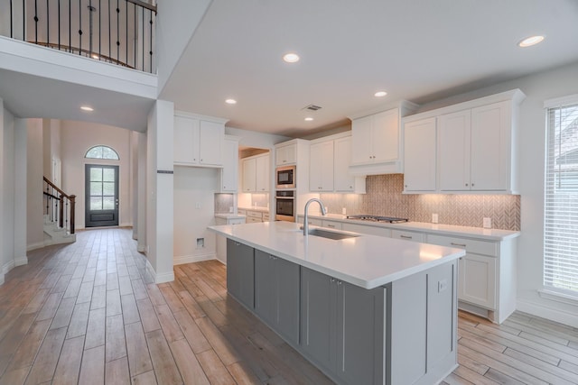 17010 Harpers Way, Conroe, TX 77385 - kitchen with stainless steel appliances, light wood-style flooring, healthy amount of natural light, a center island with sink, and recessed lighting