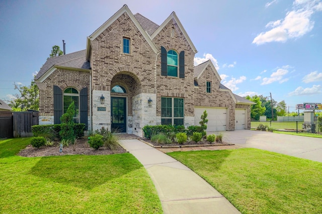 17010 Harpers Way, Conroe, TX 77385 - french country style house with brick siding, driveway, a shingled roof, and an attached garage
