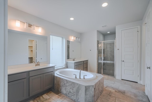 17010 Harpers Way, Conroe, TX 77385 - full bathroom featuring a shower stall, two vanities, a garden tub, and recessed lighting