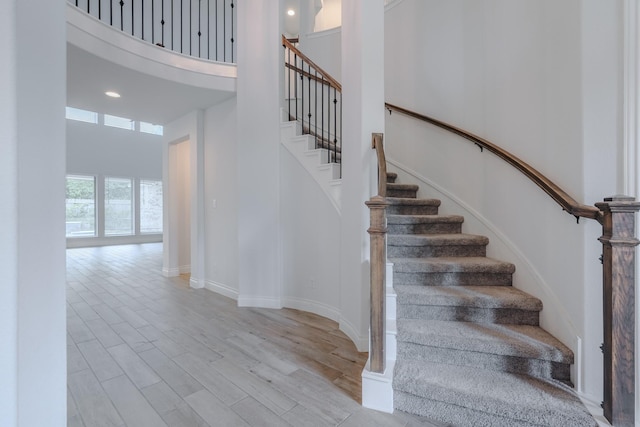 17010 Harpers Way, Conroe, TX 77385 - stairway featuring a high ceiling, wood finished floors, and recessed lighting