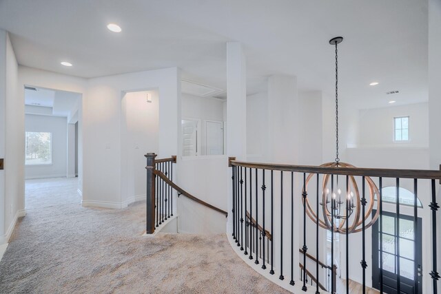 17010 Harpers Way, Conroe, TX 77385 - hallway featuring an upstairs landing, carpet, healthy amount of natural light, recessed lighting, and a chandelier