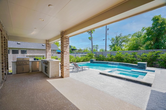 17010 Harpers Way, Conroe, TX 77385 - view of pool with an outdoor kitchen, a fenced backyard, a patio area, and a pool with connected hot tub