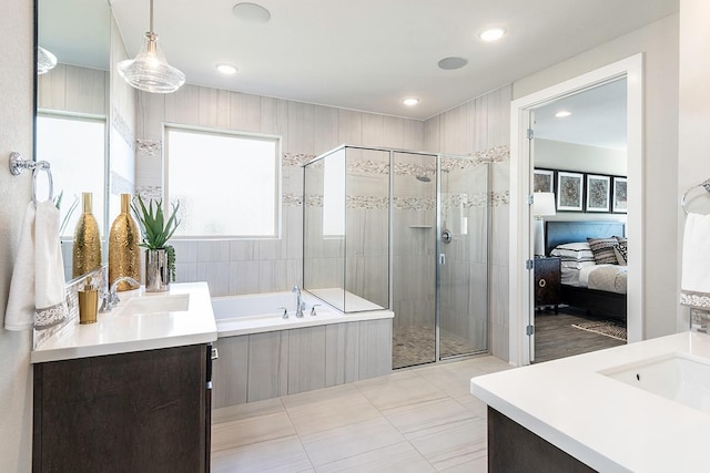 9218 Heckenberg Arbor Ln, Cypress, TX 77433 - ensuite bathroom featuring two vanities, a shower stall, a bath, recessed lighting, and tile patterned floors