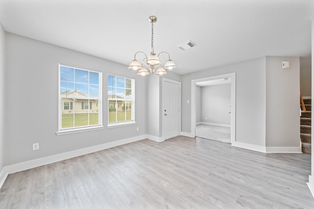 20931 Walder Ct, Katy, TX 77449 - unfurnished dining area with a chandelier, stairway, and light wood-style floors