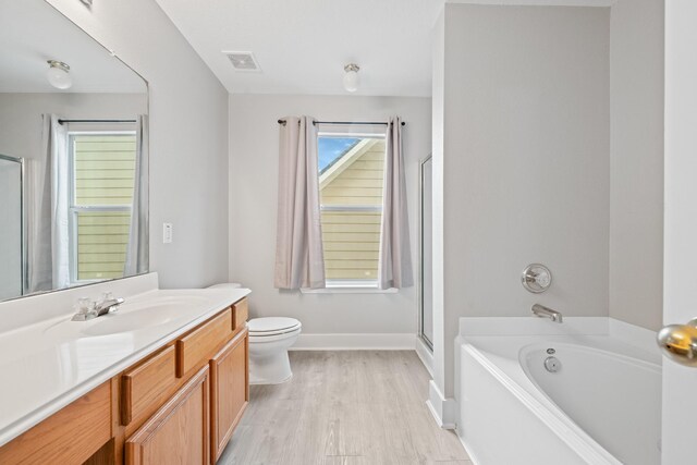 20931 Walder Ct, Katy, TX 77449 - bathroom with vanity, a bath, wood finished floors, and a shower