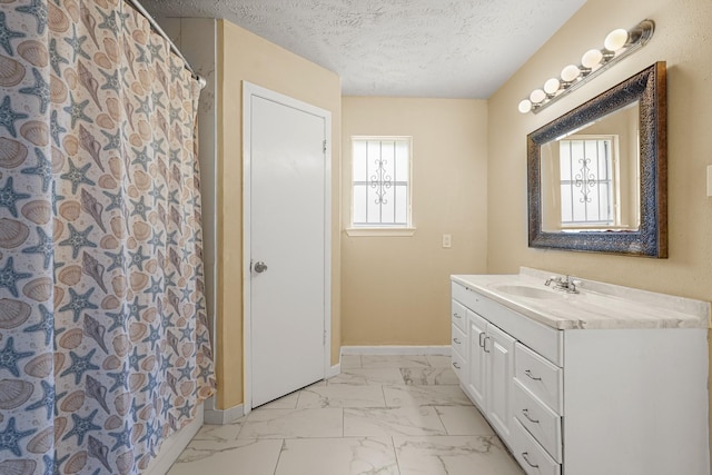 4718 Misty Shadows Dr, Houston, TX 77041 - bathroom featuring marble finish flooring, vanity, and a textured ceiling