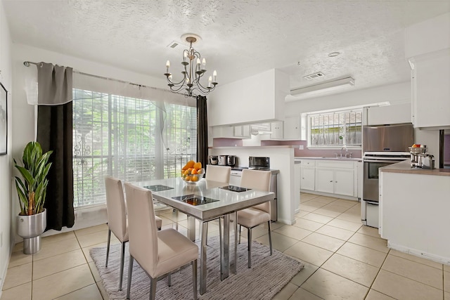 4718 Misty Shadows Dr, Houston, TX 77041 - dining space featuring a chandelier, light tile patterned flooring, and a textured ceiling