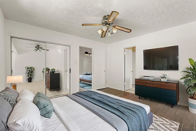 4718 Misty Shadows Dr, Houston, TX 77041 - bedroom with wood finished floors, a textured ceiling, and a ceiling fan