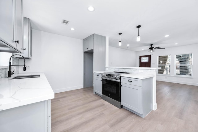 6615 Dewville Ln, Houston, TX 77076 - kitchen featuring electric stove, a ceiling fan, gray cabinets, light wood finished floors, and recessed lighting