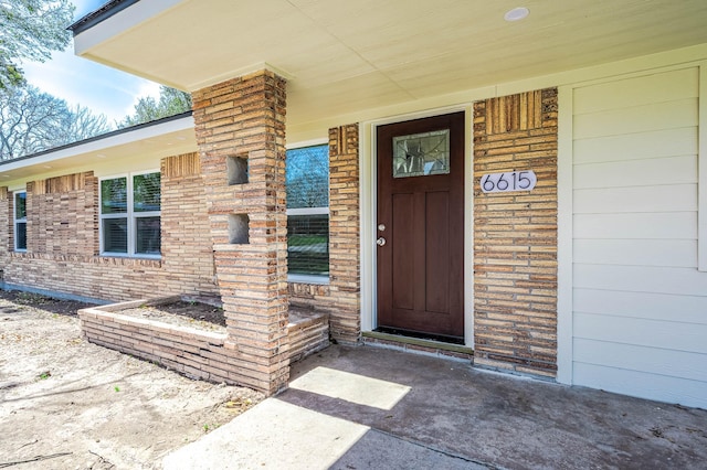 6615 Dewville Ln, Houston, TX 77076 - doorway to property featuring covered porch and brick siding