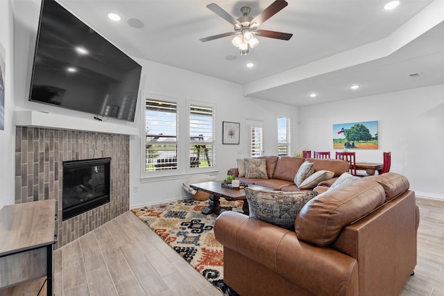 1224 Garden Jade Dr, Katy, TX 77493 - living room featuring wood finished floors, a ceiling fan, recessed lighting, and a fireplace