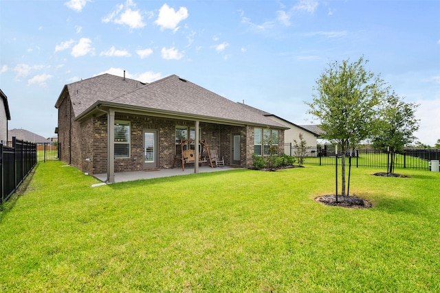 1224 Garden Jade Dr, Katy, TX 77493 - back of property featuring brick siding, a fenced backyard, a shingled roof, and a patio